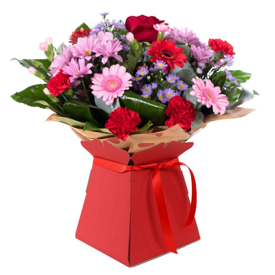 Mrs Kisses - Send lots of love and kisses with this classic hand-tied bouquet featuring a selection of romantic flowers finished with a luxurious single red rose. Deluxe is pictured.